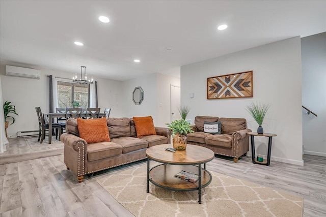 living area featuring a wall unit AC, light wood-style flooring, a notable chandelier, and recessed lighting