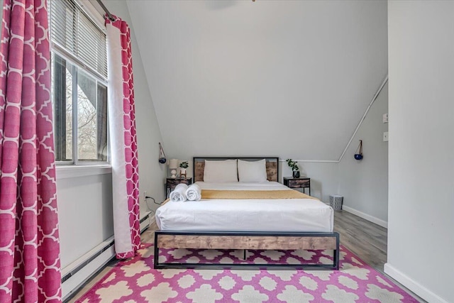 bedroom featuring wood finished floors, baseboards, a baseboard radiator, lofted ceiling, and baseboard heating