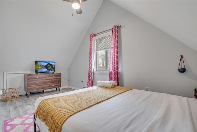 bedroom featuring a ceiling fan, vaulted ceiling, and wood finished floors