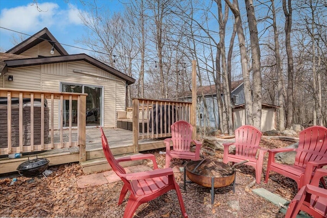 wooden deck featuring an outdoor fire pit