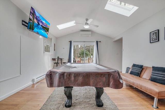 recreation room featuring ceiling fan, lofted ceiling with skylight, light wood-type flooring, a wall unit AC, and billiards