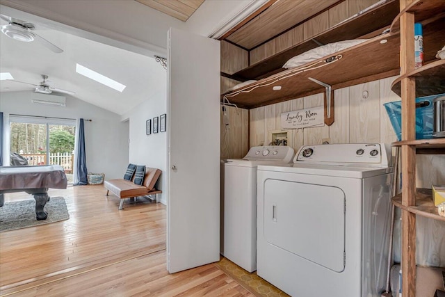 laundry room featuring billiards, a ceiling fan, a skylight, separate washer and dryer, and light wood-style floors