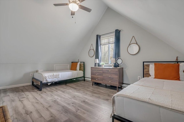 bedroom featuring a baseboard heating unit, baseboards, lofted ceiling, wood finished floors, and a ceiling fan