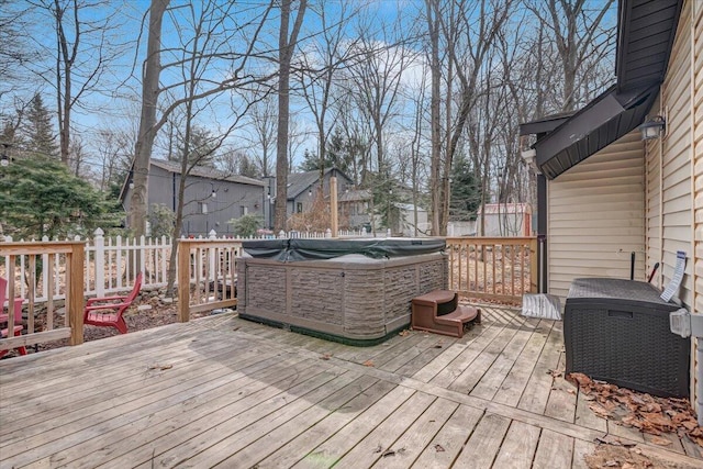 wooden deck featuring fence and a hot tub