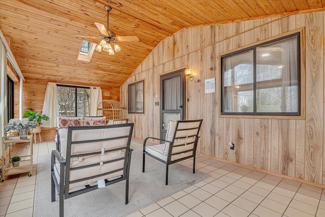 sunroom with vaulted ceiling with skylight, wooden ceiling, and a ceiling fan