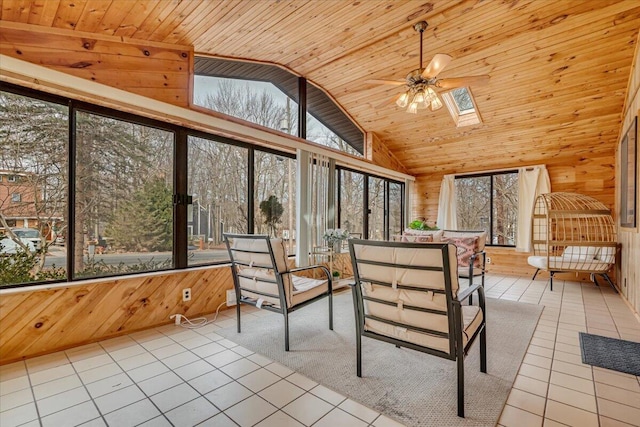 unfurnished sunroom featuring vaulted ceiling with skylight, wood ceiling, and a ceiling fan