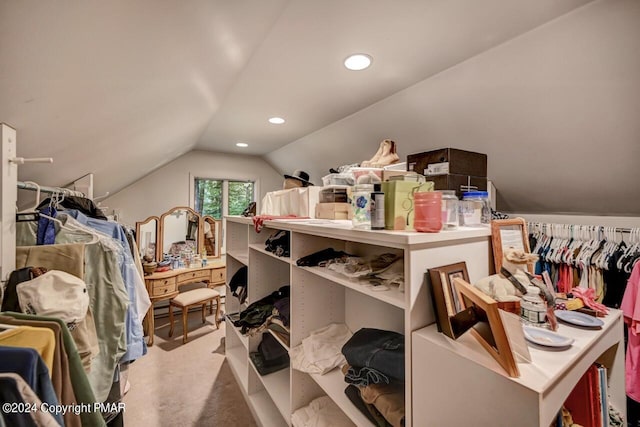 spacious closet featuring carpet floors and vaulted ceiling