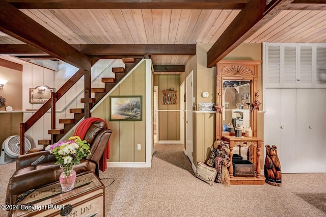 interior space featuring carpet floors, wooden ceiling, and beam ceiling