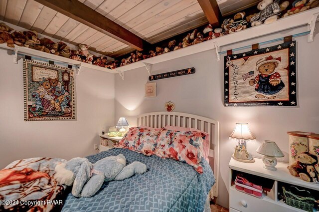 bedroom with beamed ceiling and wooden ceiling