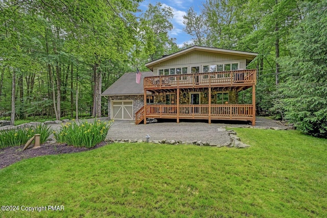 rear view of property with a garage and a lawn