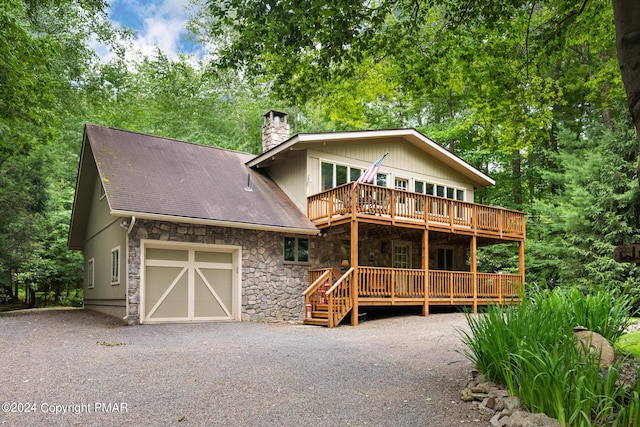 view of property with a garage and a deck