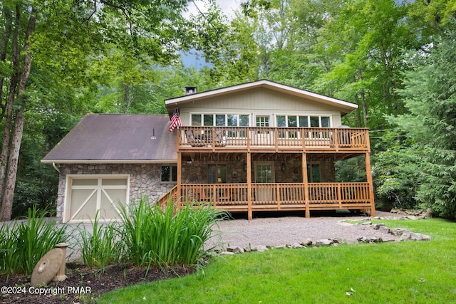 back of house with a garage and a lawn