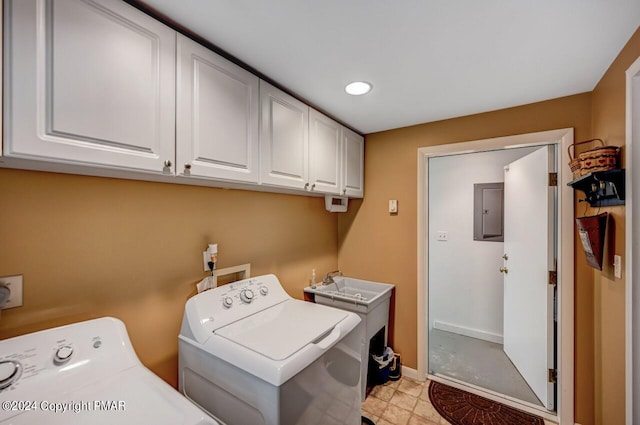 laundry room with separate washer and dryer, electric panel, and cabinets