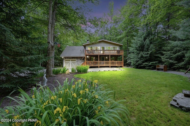 yard at dusk featuring a deck