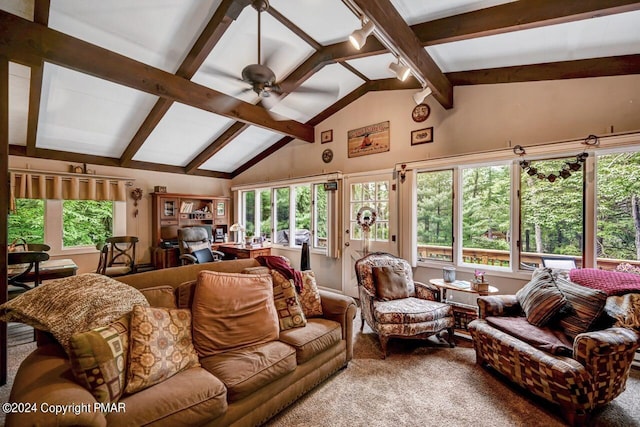 living room with vaulted ceiling with beams, a wealth of natural light, and ceiling fan