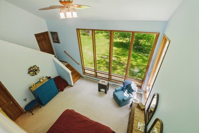 5153 Cresco Dr, Pocono Lake, PA 18347 - carpeted living area featuring a baseboard heating unit, a ceiling fan, lofted ceiling, and stairway