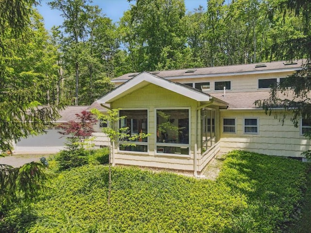 5153 Cresco Dr, Pocono Lake, PA 18347 - back of property with roof with shingles, a sunroom, and a lawn