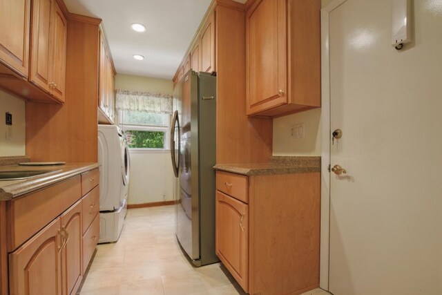 5153 Cresco Dr, Pocono Lake, PA 18347 - kitchen with freestanding refrigerator, recessed lighting, brown cabinets, and separate washer and dryer