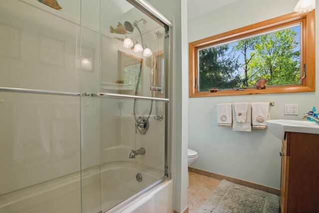 5153 Cresco Dr, Pocono Lake, PA 18347 - full bath featuring vanity, toilet, enclosed tub / shower combo, tile patterned floors, and baseboards