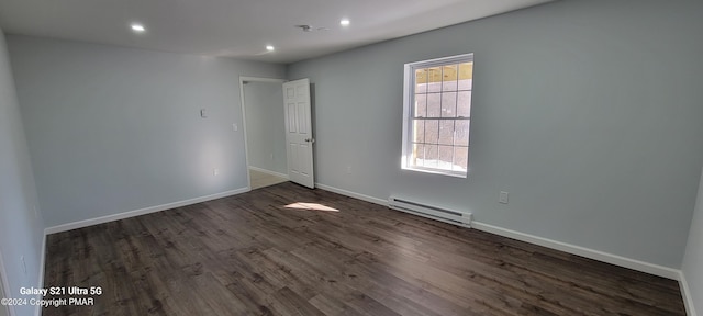 spare room featuring baseboards, baseboard heating, dark wood finished floors, and recessed lighting