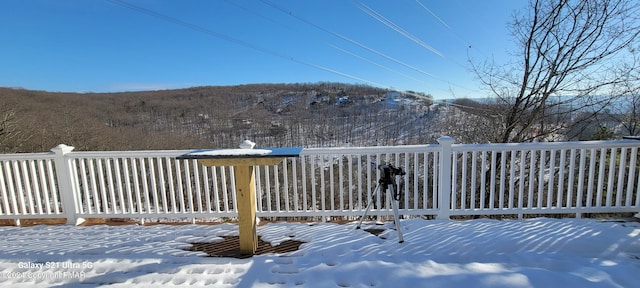 snow covered deck featuring fence