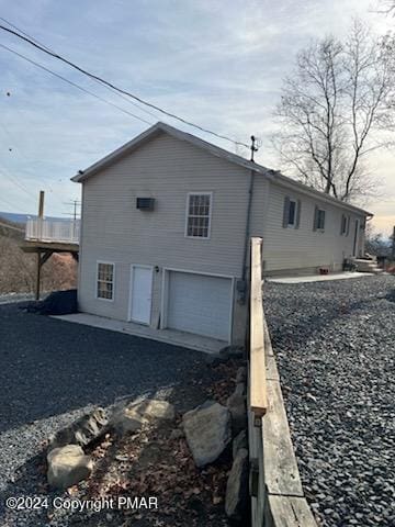 back of house featuring a garage