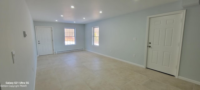 foyer with baseboards, a baseboard heating unit, and recessed lighting