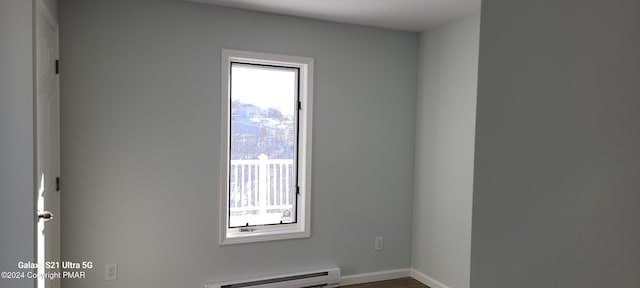 spare room featuring a baseboard radiator and baseboards