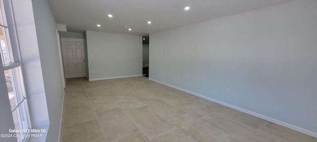 spare room with recessed lighting, baseboards, and light tile patterned floors