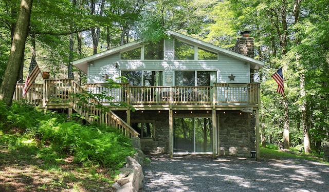 354 Fawn Rd, Pocono Lake, PA 18347 - back of house featuring a wooden deck, a chimney, and stone siding