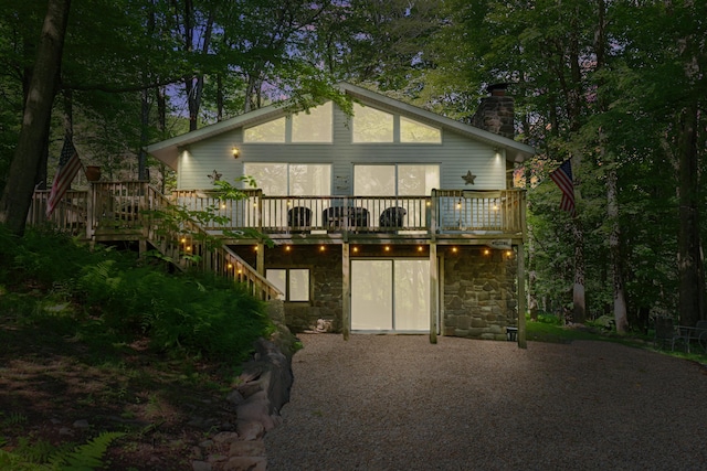 354 Fawn Rd, Pocono Lake, PA 18347 - rear view of property featuring a chimney, a deck, stone siding, and stairway