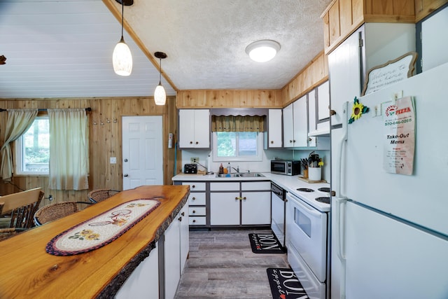 354 Fawn Rd, Pocono Lake, PA 18347 - kitchen with white appliances, white cabinetry, dark wood-style flooring, decorative light fixtures, and ventilation hood