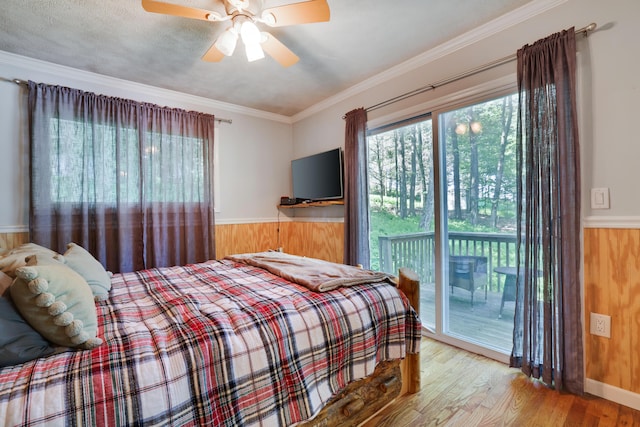 354 Fawn Rd, Pocono Lake, PA 18347 - bedroom with access to exterior, wood finished floors, wooden walls, crown molding, and a wainscoted wall
