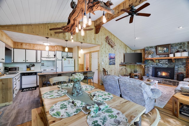 354 Fawn Rd, Pocono Lake, PA 18347 - dining space featuring wooden walls, ceiling fan, wood finished floors, wood ceiling, and a fireplace