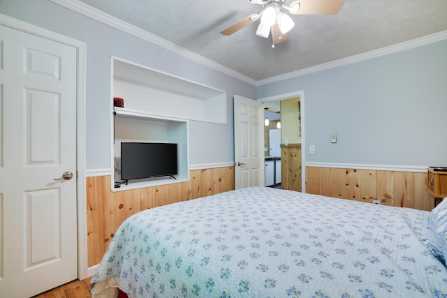 354 Fawn Rd, Pocono Lake, PA 18347 - bedroom with wainscoting, crown molding, wood finished floors, a ceiling fan, and wooden walls