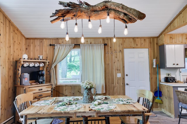 354 Fawn Rd, Pocono Lake, PA 18347 - dining area featuring a baseboard radiator, wood finished floors, and wood walls