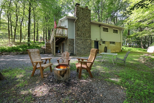 354 Fawn Rd, Pocono Lake, PA 18347 - back of property with a fire pit, stairway, a chimney, and a wooden deck