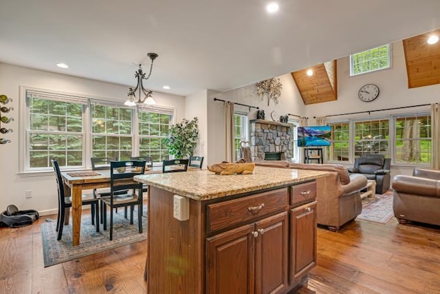 141 Beech Ln, Pocono Lake, PA 18347 - kitchen with open floor plan, hardwood / wood-style flooring, a kitchen island, a fireplace, and recessed lighting