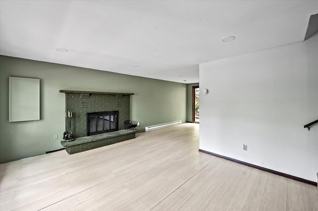6061 Decker Rd, Bushkill, PA 18324 - unfurnished living room featuring a baseboard radiator, wood finished floors, and a fireplace