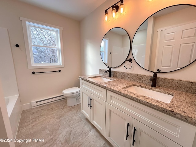 full bathroom featuring toilet, a baseboard radiator, double vanity, and a sink