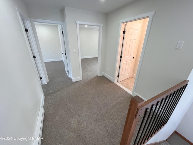 hall with carpet floors and baseboards