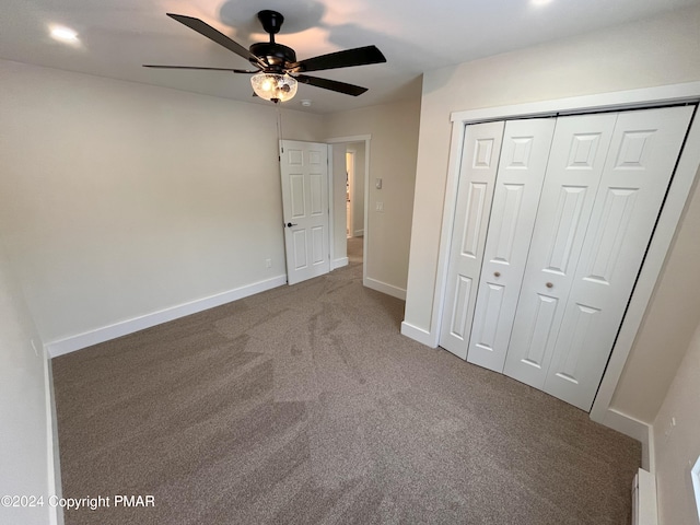 unfurnished bedroom with a ceiling fan, a closet, carpet flooring, and baseboards