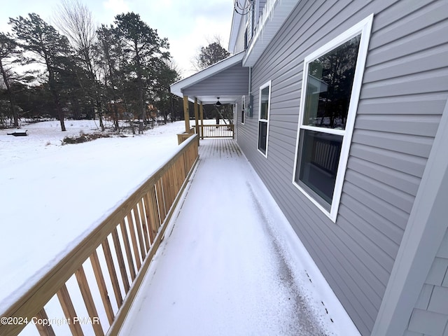 snow covered deck with a ceiling fan