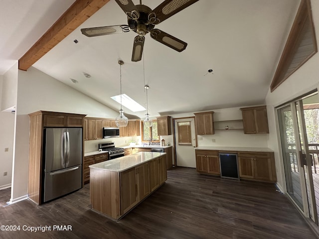 kitchen with a kitchen island, dark wood finished floors, beam ceiling, ceiling fan, and appliances with stainless steel finishes