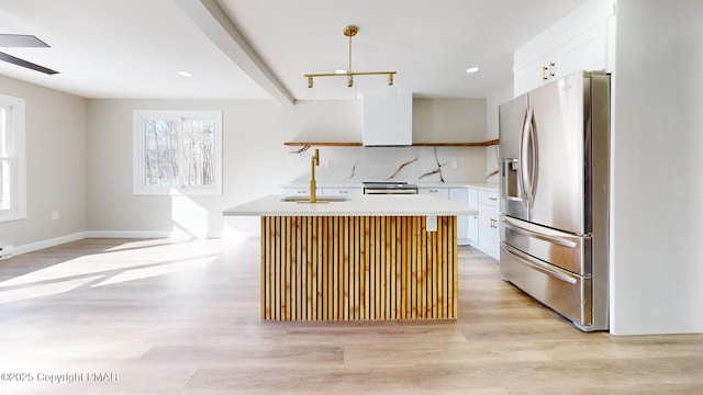 182 Mallard Ln, Albrightsville, PA 18210 - kitchen featuring light wood-style flooring, a kitchen island with sink, stainless steel refrigerator with ice dispenser, and a sink