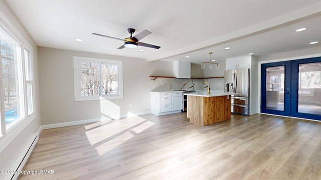 182 Mallard Ln, Albrightsville, PA 18210 - kitchen featuring french doors, light wood finished floors, stainless steel appliances, light countertops, and baseboard heating