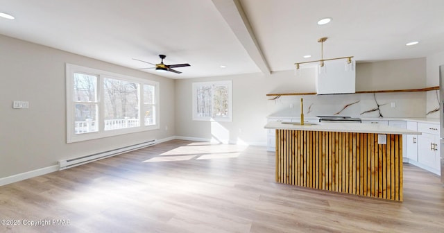 182 Mallard Ln, Albrightsville, PA 18210 - kitchen with light wood-style flooring, baseboard heating, light countertops, white cabinetry, and recessed lighting