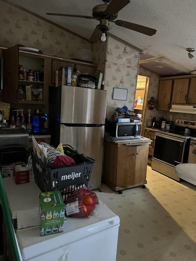 3175 Pocono Dr, East Stroudsburg, PA 18302 - kitchen featuring wallpapered walls, stainless steel appliances, vaulted ceiling, under cabinet range hood, and a textured ceiling