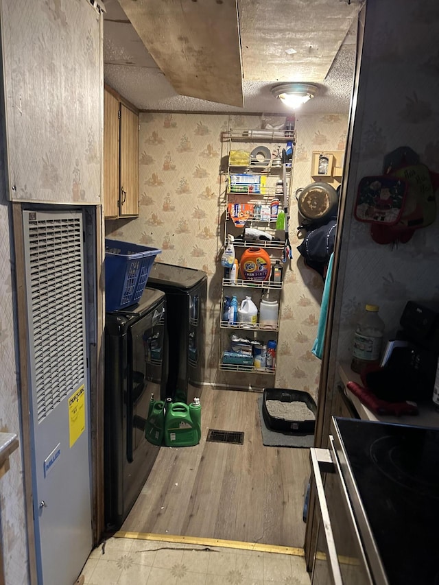 3175 Pocono Dr, East Stroudsburg, PA 18302 - kitchen featuring wallpapered walls, a heating unit, and wood finished floors