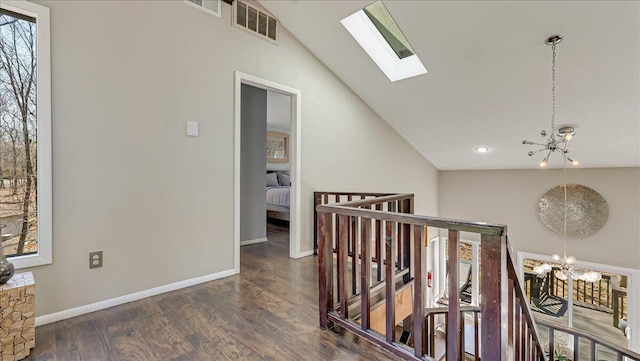 3206 Stonehenge Dr, East Stroudsburg, PA 18301 - hall with an inviting chandelier, baseboards, wood finished floors, visible vents, and lofted ceiling with skylight